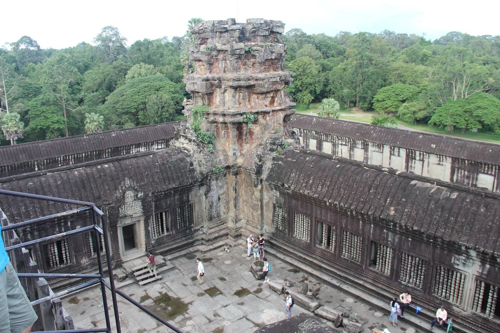 An elevated view of a weathered stone tower and courtyard within Angkor Wat temple in Siem Reap.