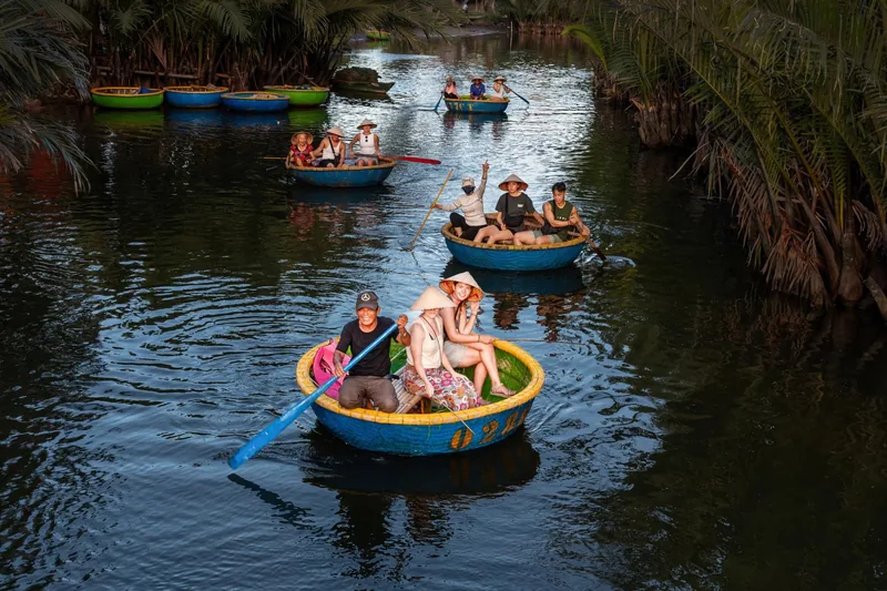 Tourists paddle round bamboo basket boats along the palm-lined water coconut village near Hoi An.