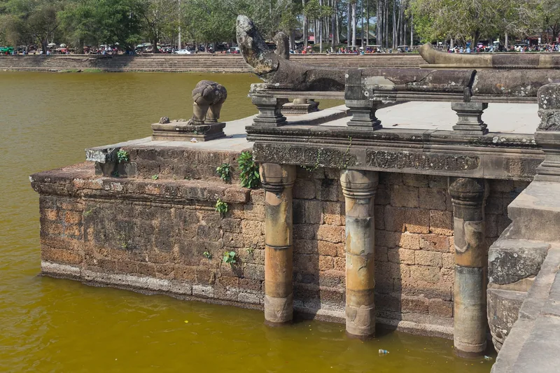 Stone naga balustrade and pillars rise from the moat at Angkor Wat in Siem Reap.