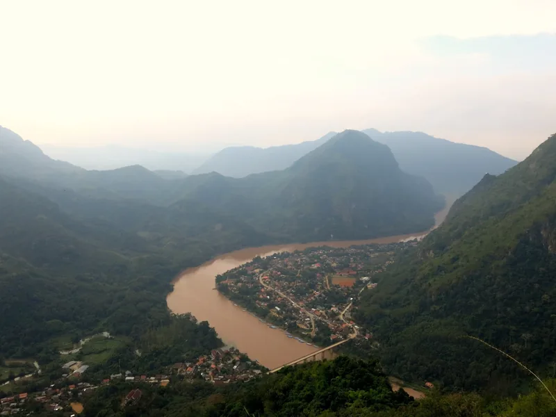 Aerial view of Nong Khiaw town nestled between limestone mountains along the Nam Ou River in Laos.